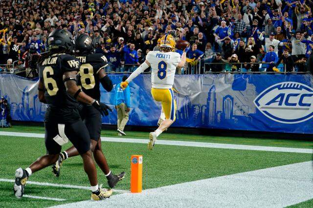 Pittsburgh quarterback Kenny Pickett celebrates after scoring against Wake Forest on a 58-yard run during the first quarter of the Atlantic Coast Conference championship NCAA college football game Saturday, Dec. 4, 2021, in Charlotte, N.C. 